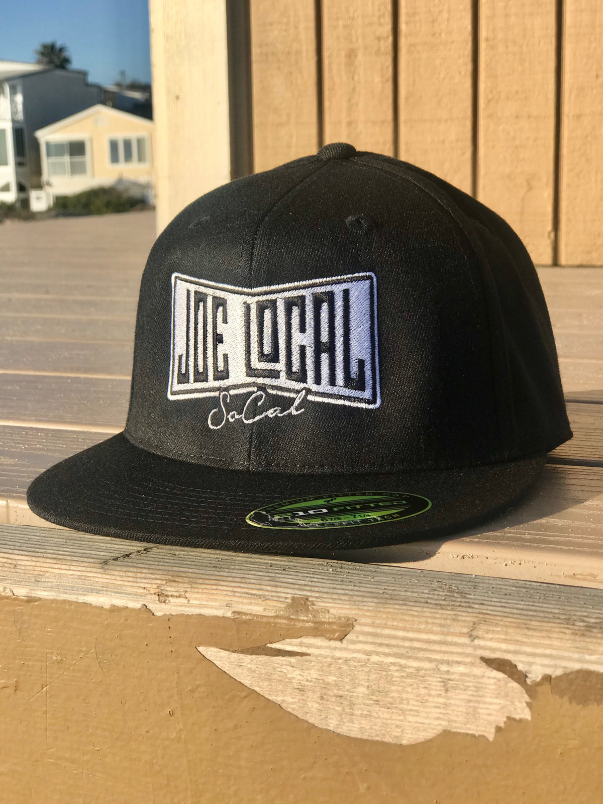 Black flat bill cotton cap. Black and white embroidered Joe Local So Cal flag logo. Flex fit, premium fitted cap