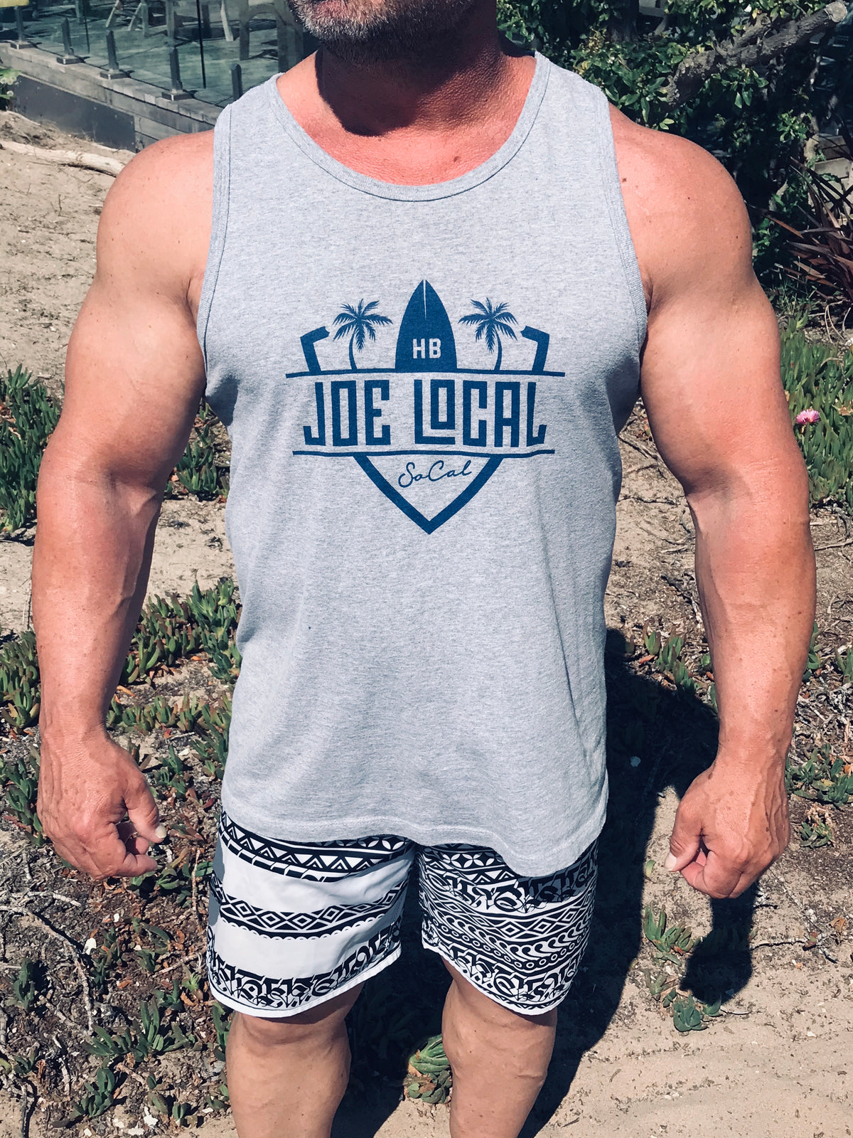 Joe Local SoCal Tank Top Athletic Heather w/Dark Blue SoCal/HB shield Logo 50:50 Cotton / Polyester blend  4.8 oz / 165 gram Joe Local SoCal/HB shield Logo on front Joe Local Logo on back .