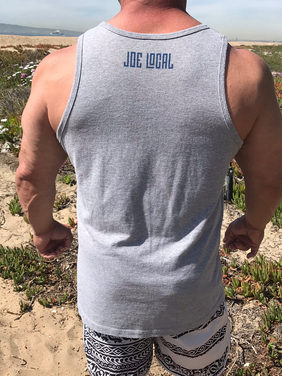 Joe Local SoCal Tank Top Athletic Heather w/Dark Blue SoCal/HB shield Logo 50:50 Cotton / Polyester blend 4.8 oz / 165 gram Joe Local SoCal/HB shield Logo on front Joe Local Logo on back.